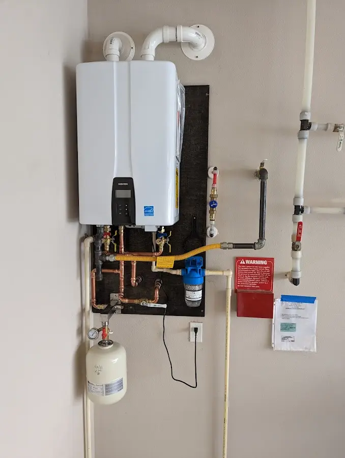 Professional plumber installing copper piping in a North Olmsted home